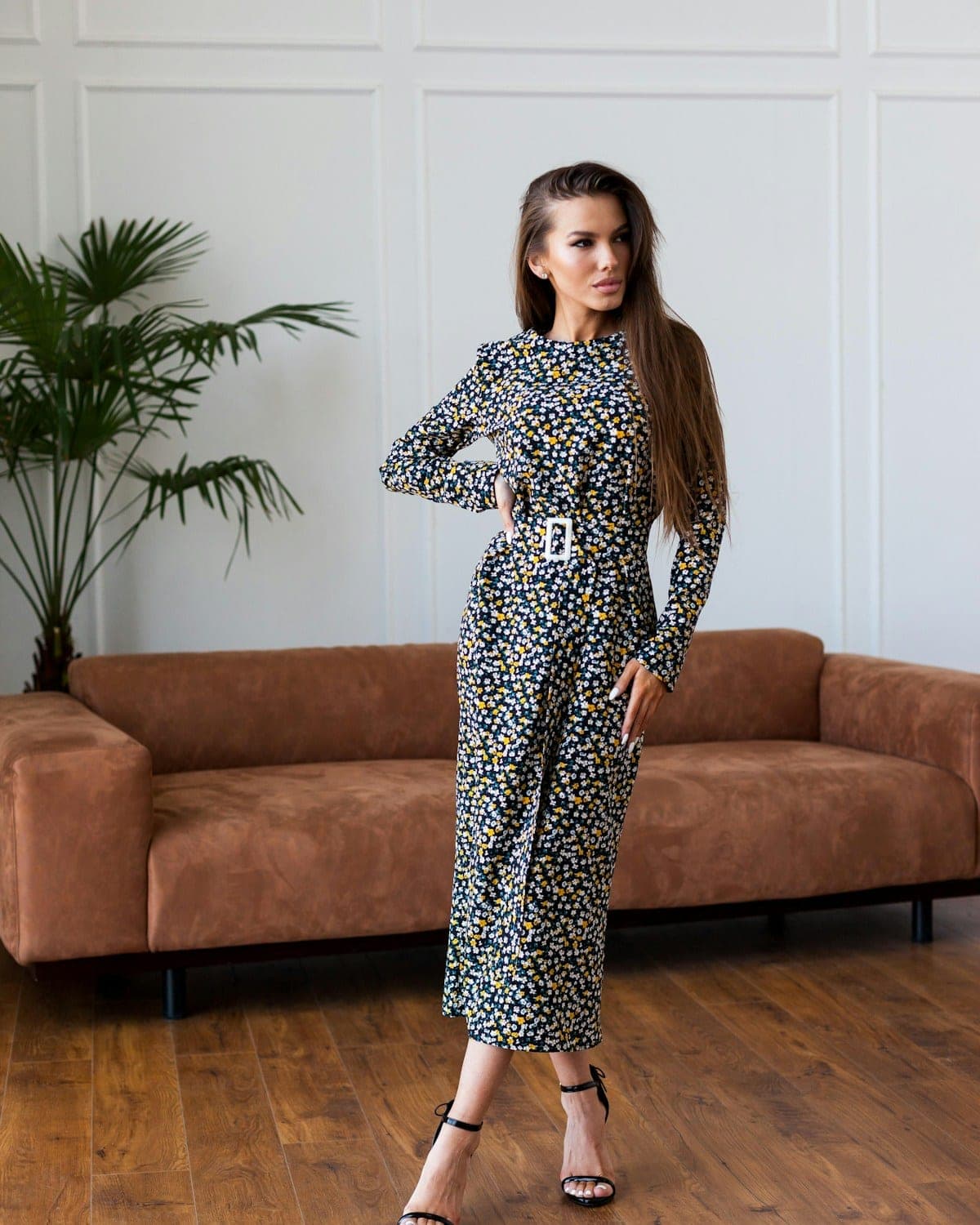 Woman in a belted long-sleeved printed midi dress