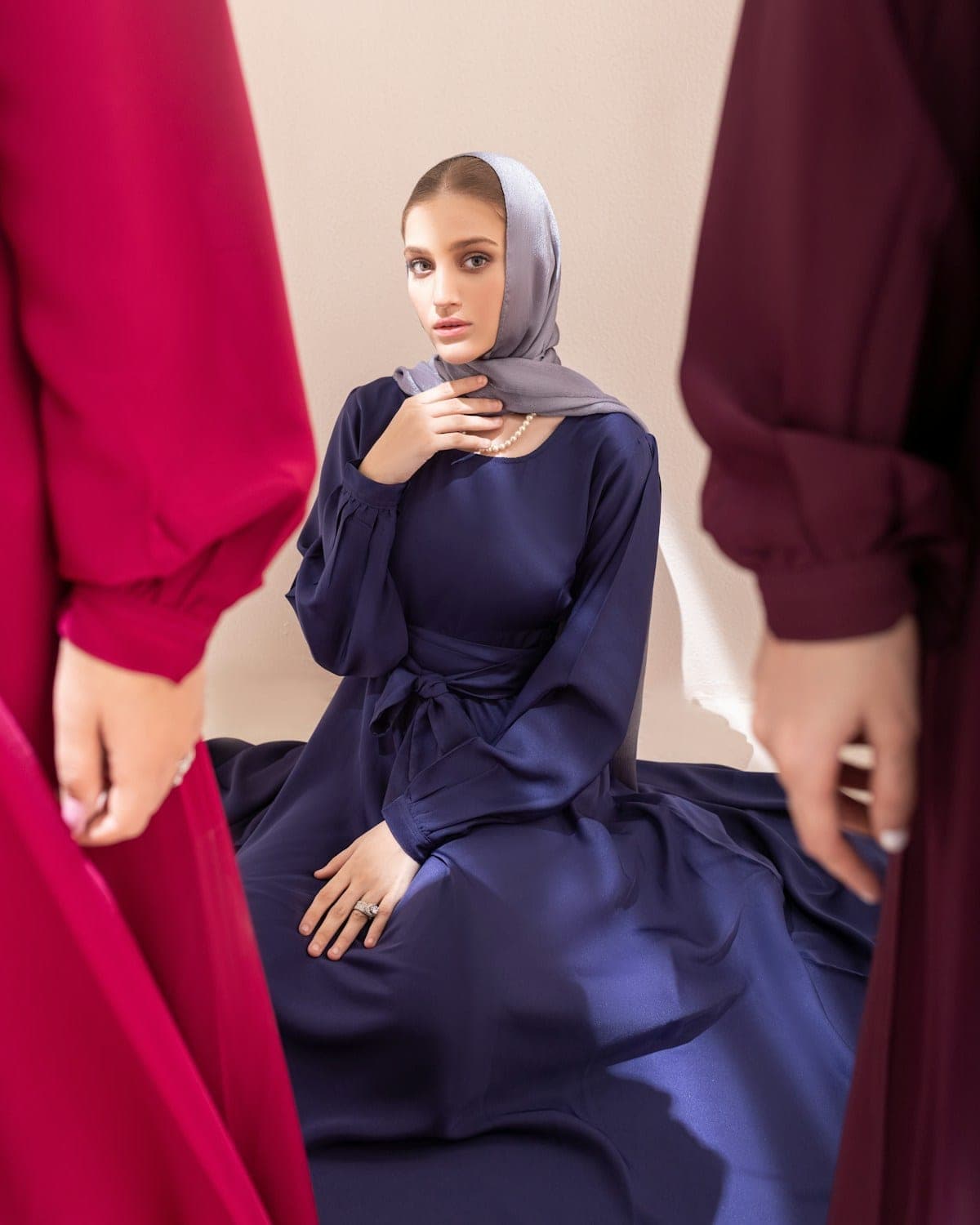 Woman in a navy abaya and grey headscarf